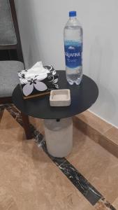 a bottle of water sitting on top of a table at LOKAL Rooms x Multan (City Center) in Multan