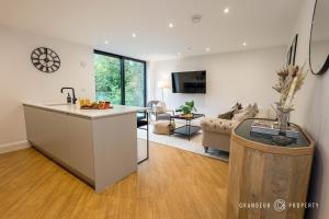 a kitchen and living room with a sink and a counter at NEW Elegant apartment, 2 bed, balcony, Poole - Aurora's Abode in Parkstone