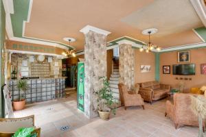 a lobby of a store with couches and a tv at Hikmethan Otel in Kuşadası