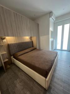a bedroom with a large bed in a room at Hotel Villa Itala in Rimini