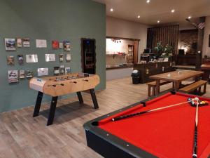 a room with a table and a pool table at LA GRANGE DES FRANGINES in Saint-Amour