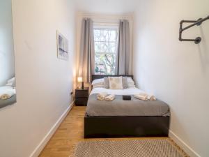 1 dormitorio con cama y ventana en Pass the Keys Cosy 2 Bedroom Apartment near city centre, en Nottingham