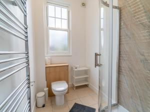 a bathroom with a toilet and a window and a shower at Pass the Keys Cosy 2 Bedroom Apartment near city centre in Nottingham