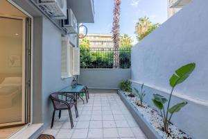 a small balcony with two chairs and a table at The 626 Park Apartment in Heraklio