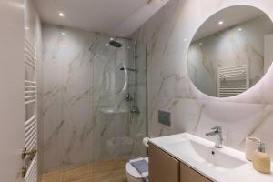 a bathroom with a shower and a sink and a mirror at The 626 Park Apartment in Heraklio +5 photos
