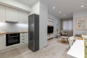 a kitchen with a stainless steel refrigerator and a living room at The 626 Park Apartment in Heraklio