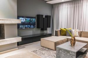 a living room with a couch and a tv at Beautifully Designed 3BR Apartment+ Panoramic View in Rabat