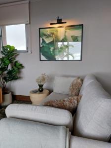 - un salon avec un canapé et une photo sur le mur dans l'établissement Casa Atlantico tropischer Seitenflügel, à Ribeira Brava