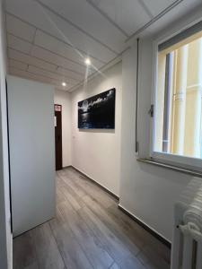 a hallway with a window and a painting on the wall at Hotel Villa Itala in Rimini