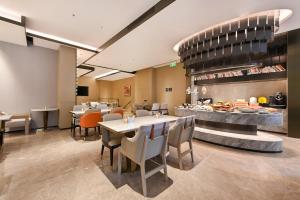 a restaurant with tables and chairs and a buffet at Atour Hotel Shenyang Nanta Wenhua Road in Shenyang