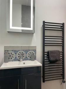 a bathroom with a sink and a mirror at The Butcher's Flat Seahouses in Seahouses