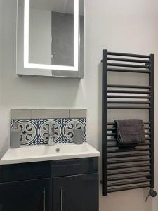 a bathroom with a sink and a mirror at The Butcher's Flat Seahouses in Seahouses +16 photos