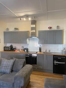 a living room with a couch in a kitchen at The Butcher's Flat Seahouses in Seahouses