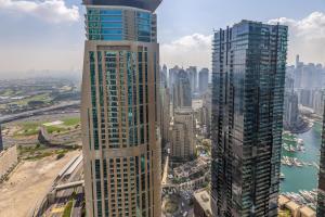 an aerial view of two tall buildings in a city at Maison Privee - Modern Urban Retreat in the Heart of Dubai Marina in Dubai
