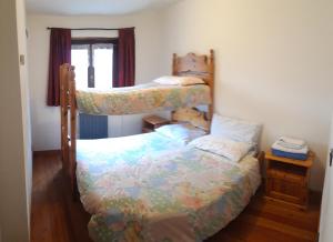 a bedroom with two bunk beds and a window at Rifugio "Mai Tardi" in Madesimo