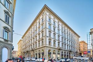 a large white building on a city street at Duomo Luxury Florence in Florence