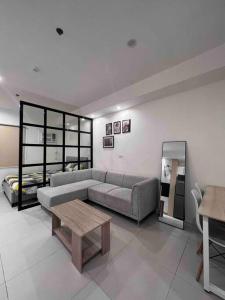 a living room with a couch and a coffee table at Studio unit in Prime Location in Davao City