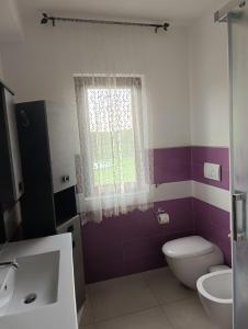 ein Bad mit einem WC und einem Fenster in der Unterkunft Tenuta Quadrone in Cura