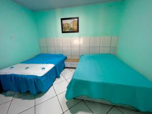 Ένα ή περισσότερα κρεβάτια σε δωμάτιο στο Casa no Rio de Janeiro