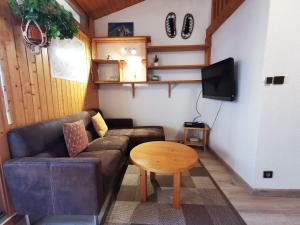 ein Wohnzimmer mit einem Sofa und einem Tisch in der Unterkunft Clos du Savoy - Chamonix Center - Skii on foot in Chamonix-Mont-Blanc