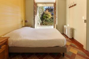 a bedroom with a bed and an open window at Le Petit Eloi in Saint-Gervais-les-Bains