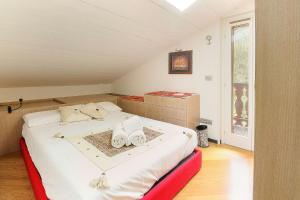 a bedroom with a bed with shoes on it at Appartement Yoga - Vues Chaîne du Mont-Blanc - Calme - Espace Yoga Spacieux in Les Trabets