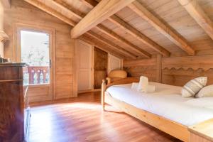 a bedroom with a bed in a wooden house at Les Cristalliers - Cozy family chalet - Close to the village in Les Houches