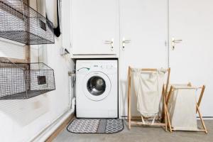 a washer and dryer in a laundry room with white cabinets at Les Cristalliers - Cozy family chalet - Close to the village in Les Houches