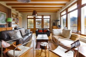 a living room with a couch and chairs and windows at Saint Éloi - Panoramic view - Mont Joly - Central in Saint-Gervais-les-Bains