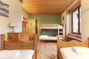 two beds in a room with two bunk beds at Saint Éloi - Panoramic view - Mont Joly - Central in Saint-Gervais-les-Bains