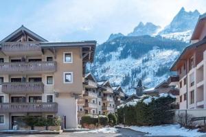 a group of buildings in front of a mountain at Le Petit Paradis - Indoor pool and sauna in Chamonix-Mont-Blanc