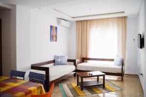 a living room with a couch and a table at Residence Trust in Sousse