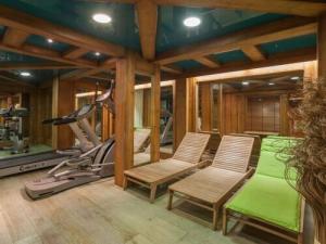 a gym with two chairs and a treadmill at Le Petit Paradis - Indoor pool and sauna in Chamonix-Mont-Blanc