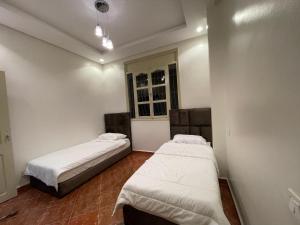 Tempat tidur dalam kamar di Fayb-Sweet-Home-3 - El-Wifaq