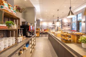 a grocery store with a long aisle with food at Ramada The Hague Scheveningen in Scheveningen
