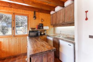 a kitchen with wooden cabinets and a wooden counter top at Chalet Charousse in Les Houches