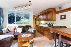 a living room with a couch and a table at Le Grand Tetras - Beside Lake Chavants, TMB staring point & Hikes in Les Houches