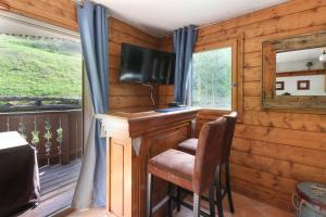 a wooden room with a desk and a television at Le Grand Tetras - Beside Lake Chavants, TMB staring point & Hikes in Les Houches