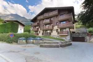 a building with two trash cans in front of it at Le Grand Tetras - Beside Lake Chavants, TMB staring point & Hikes in Les Chavants