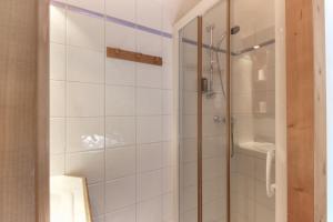 a bathroom with a shower with a glass door at Le Grand Tetras - Beside Lake Chavants, TMB staring point & Hikes in Les Chavants +15 photos