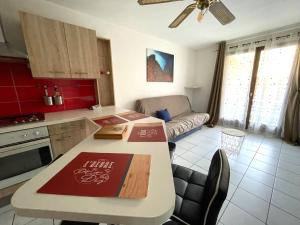 a kitchen with a table and a living room at Havre de paix Annécien in Meythet