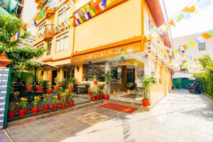 a store with potted plants in front of a building at Magnificent Hotel in Kathmandu