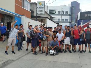 a group of people posing for a picture on a sidewalk at HOSTAL SAN MARINO in Manta