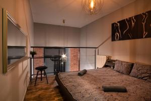 a bedroom with a bed in a room with a fireplace at Dream Aparts - Lofty Scheiblera in Łódź