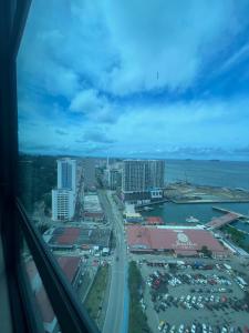 an aerial view of a city with buildings and a highway at Petronella Suites Apartment @ Jesselton Quay in Kota Kinabalu