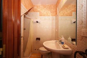 a small bathroom with a toilet and a sink at Casa Agrelo Ria de Noia in Argellas +37 photos
