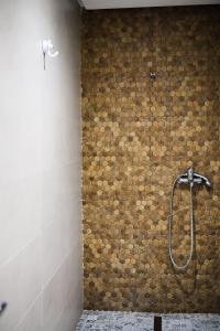 a shower in a bathroom with a stone wall at Residence Trust in Sousse +123 photos