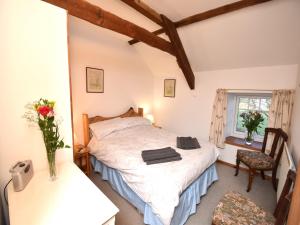 Stocksfield的住宿－3 bed in Hexham 32252，卧室配有床、椅子和窗户。