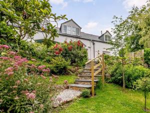 a house with a garden with a wooden stairway at 3 Bed in Bucks Mills OLDSB in Bucks Mills
