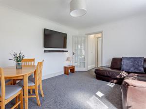 a living room with a table and a couch at 2 bed in Bath 05135 in Chew Magna